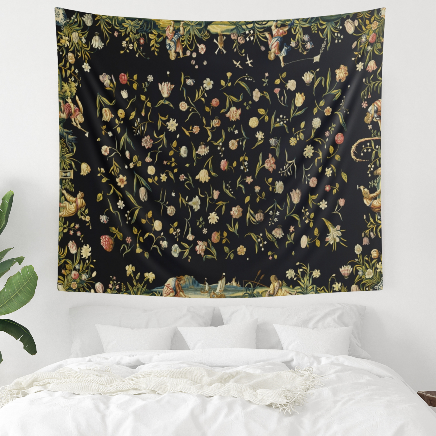 a bed with a black floral tapestry hanging above it